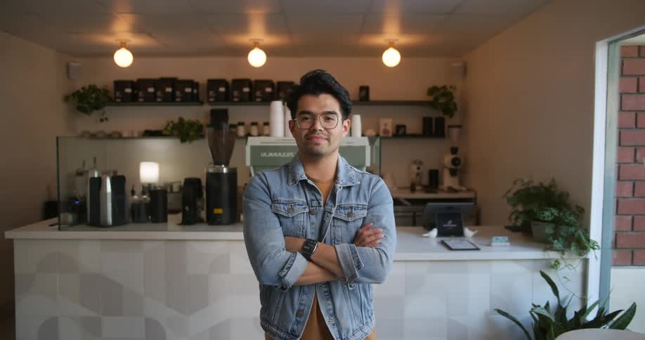 A man is standing in his kitchen during the day time