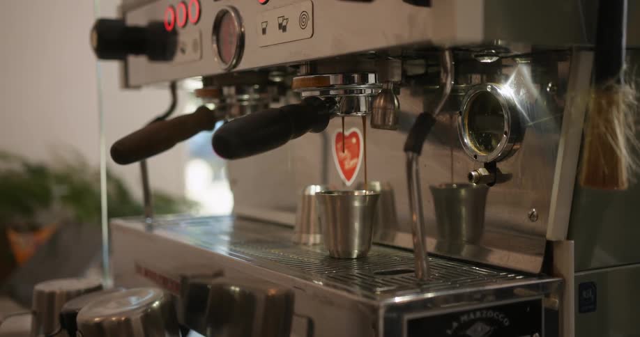 The view is of a coffee shop and someone is making coffee