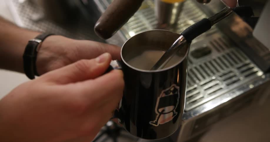 Barista prepares a cup of coffee in the espresso machine