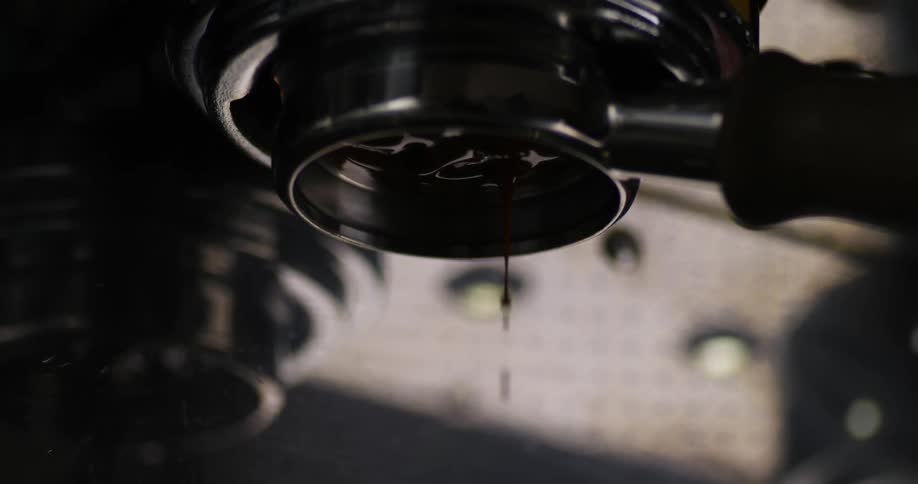 Coffee drops fall from commercial grade coffee machine