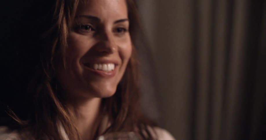 A woman smiles and laughs