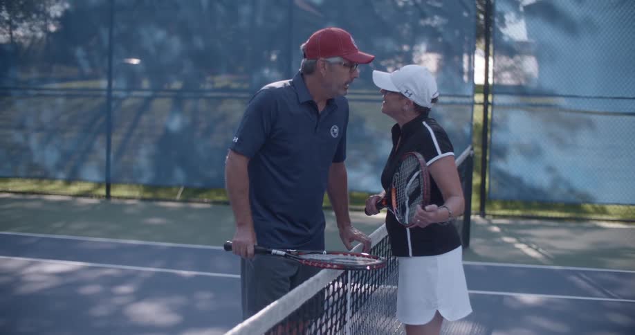 Retired Couple on Vacation Playing Tennis