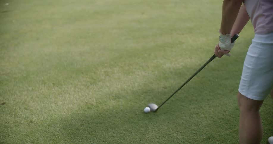 An older woman plays golf