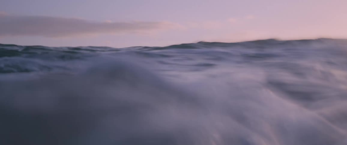 The setting sun reflects off ocean waves