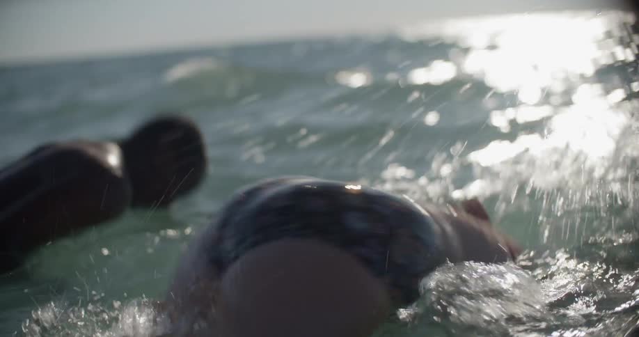 A man and woman swim in the ocean
