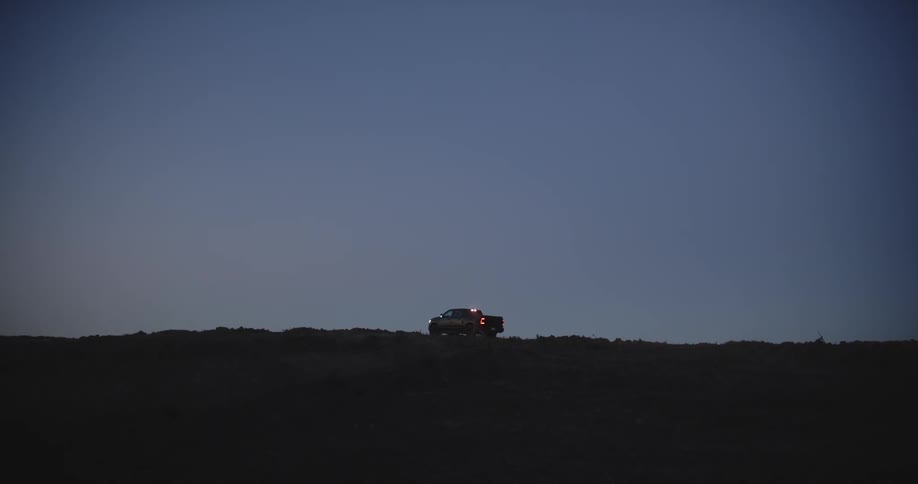 A person walking around near a truck outdoors