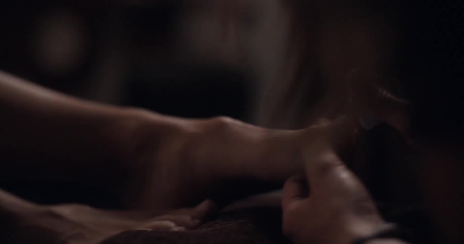 A person giving someone a pedicure