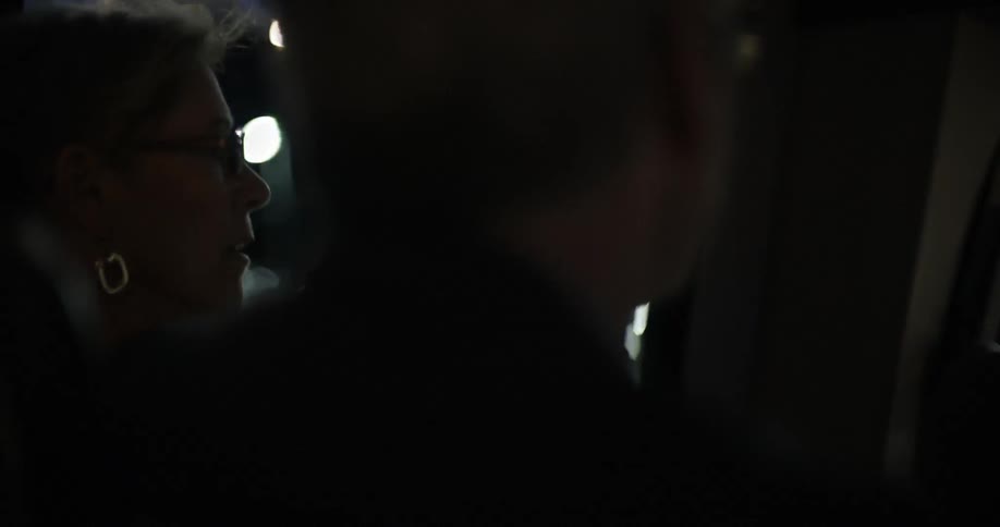 A man and woman having a heated discussion at night