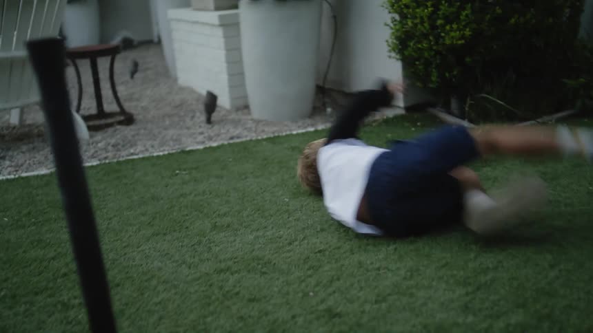 A father and son playing baseball in the yard