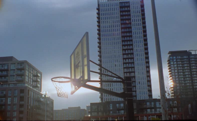 A basketball hoop outside of apartment buildings