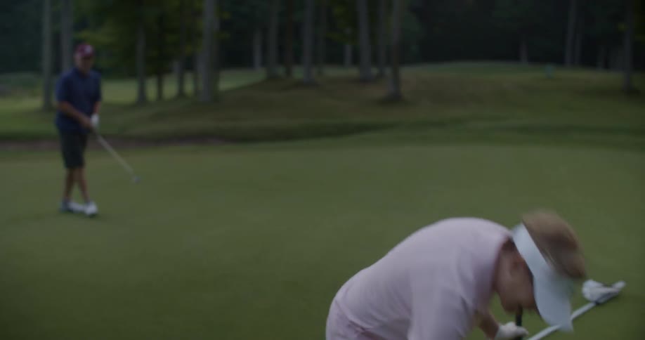 An older man and woman golfing