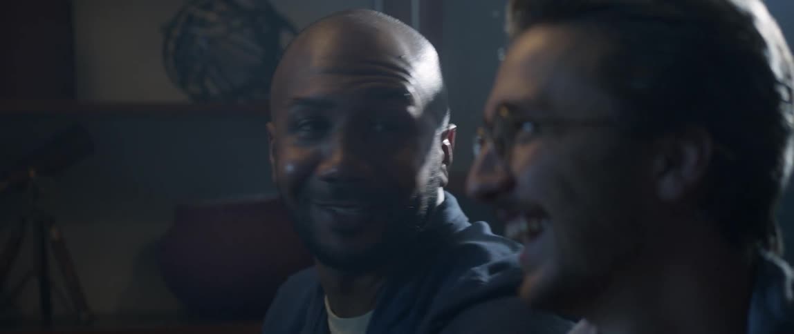 Two adult friends have fun playing video games at home
