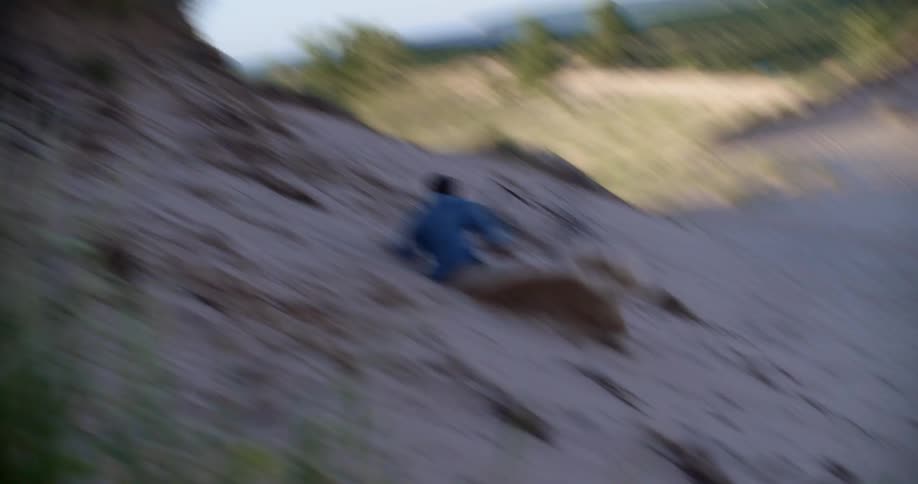 A man runs and jumps off of a hill