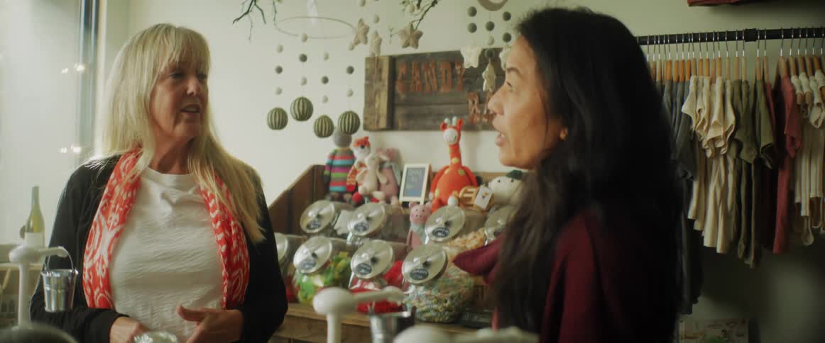 Customer talking to shop owner in a retail store