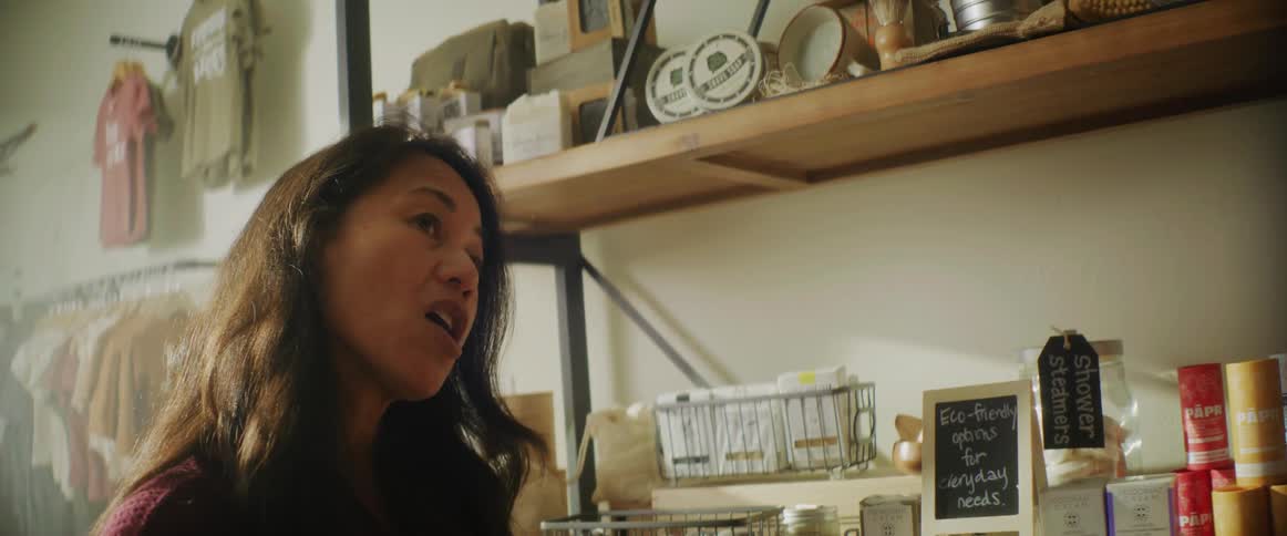 The employee is talking to someone in the shop