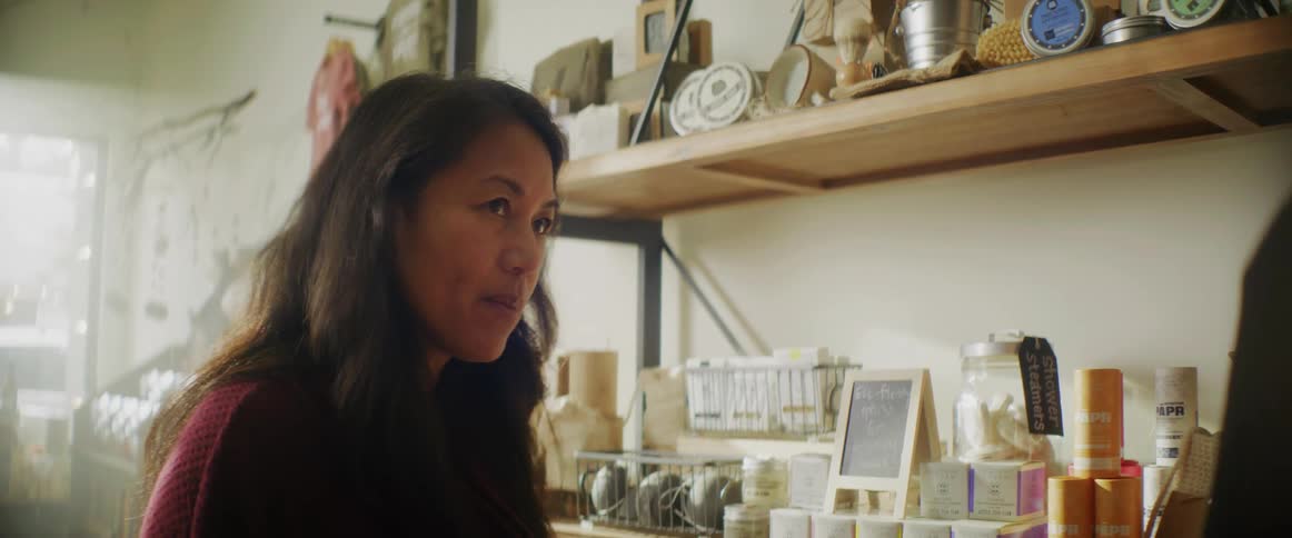 A woman speaks with a customer in her business