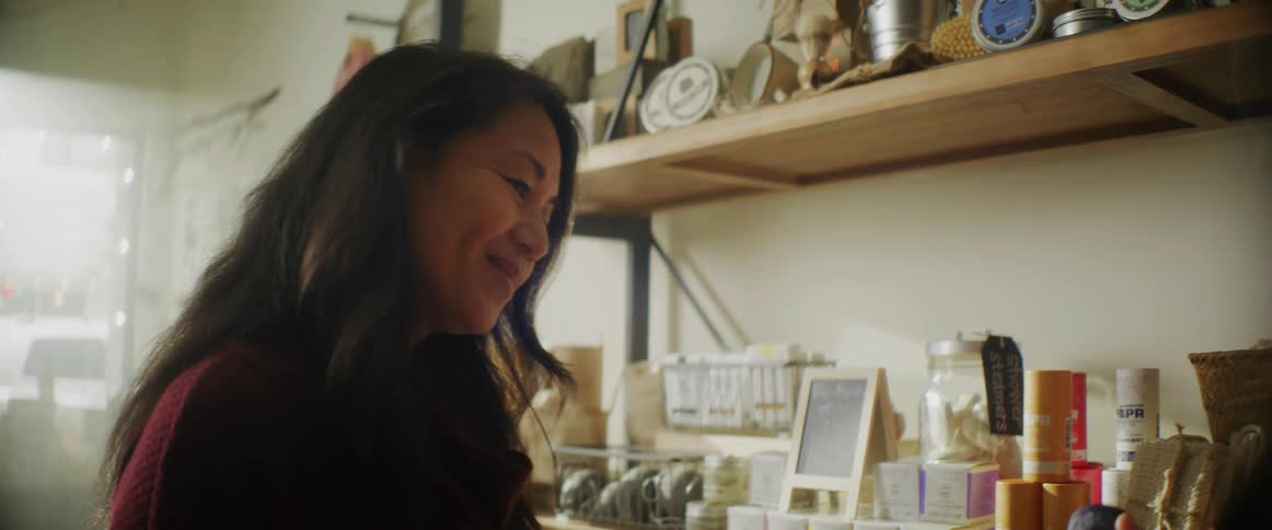 A woman is looking at items in a store