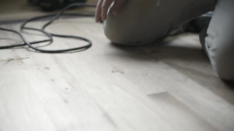 A man is wiping a wooden floor