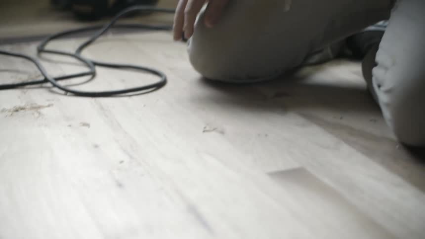 A man is wiping a wooden floor