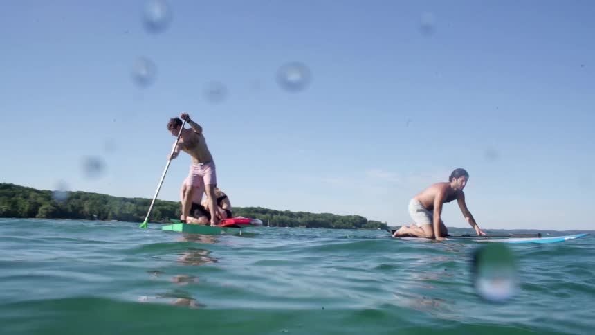 People paddle boarding during the day