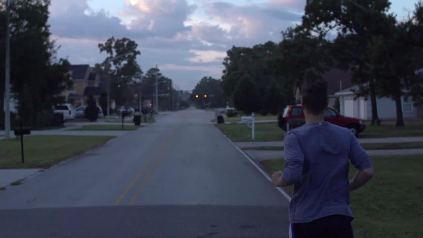 A man jogs down a road