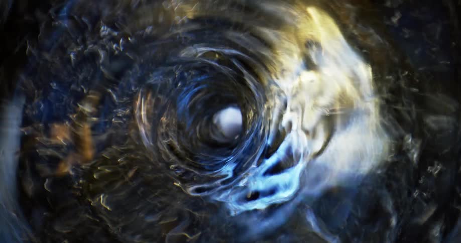 Light reflects on the sides of a spinning tunnel vortex as it moves