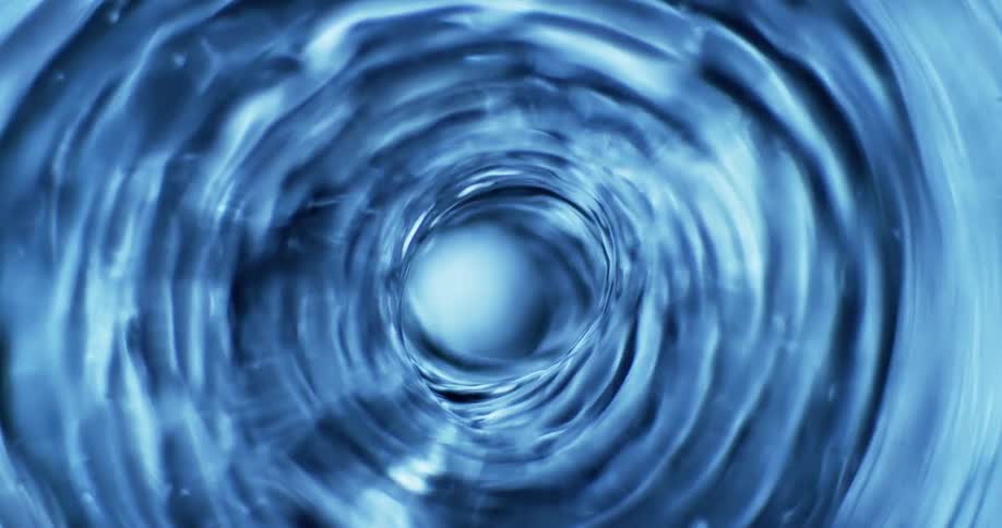 Light flashes on a blue swirling vortex as it rapidly spins