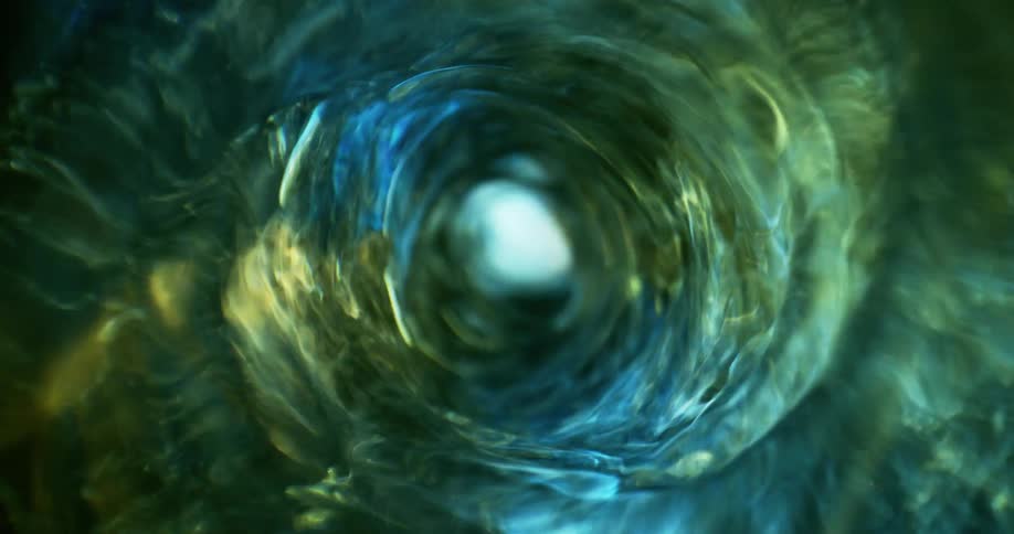 Bluish green water swirls in a vortex
