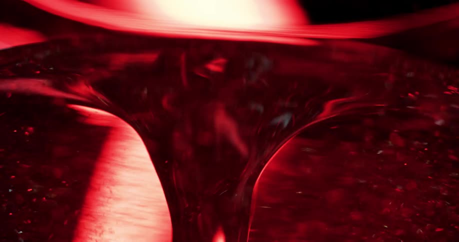 Particles move around a red swirling object as a light randomly flashes