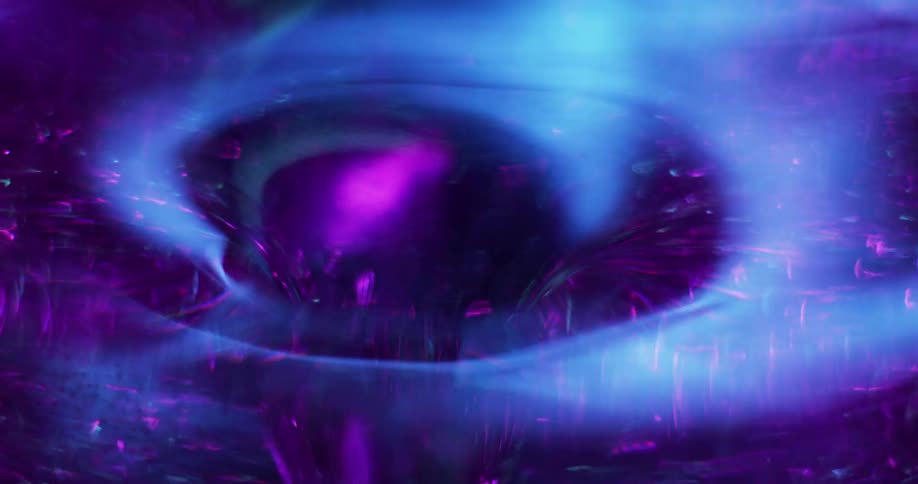Particles bounce and move around a purple swirling vortex as a violet light shines on the surface