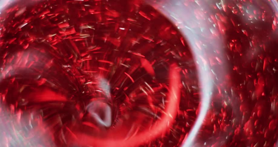 Particles move around a red swirling tunnel as a light randomly flashes