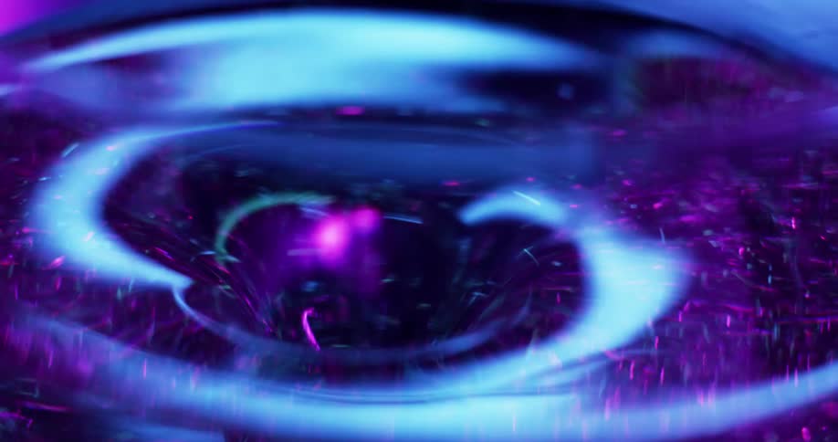 Blue light shines on a swirling purple tunnel vortex with pink particles as it moves