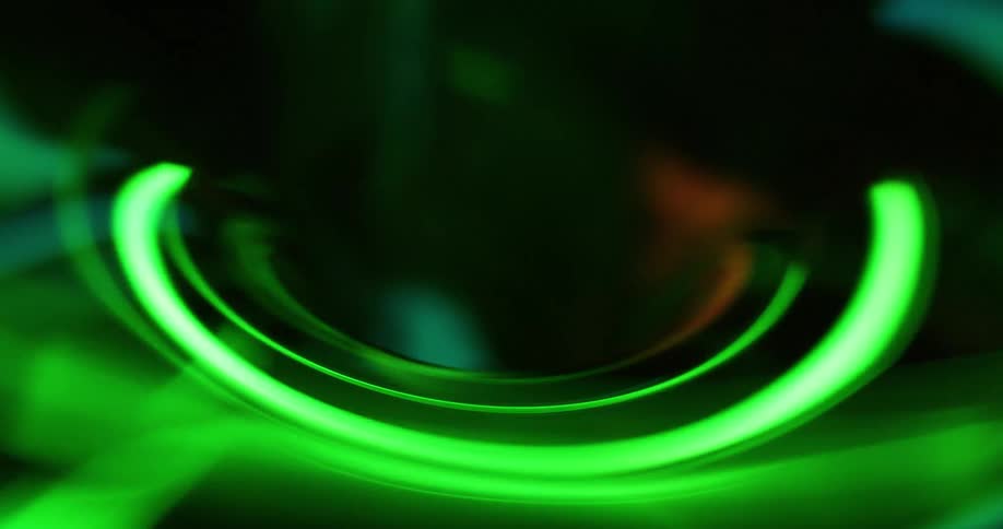 Light around a vortex changes colors as it moves and swirls into the hole as it vibrates