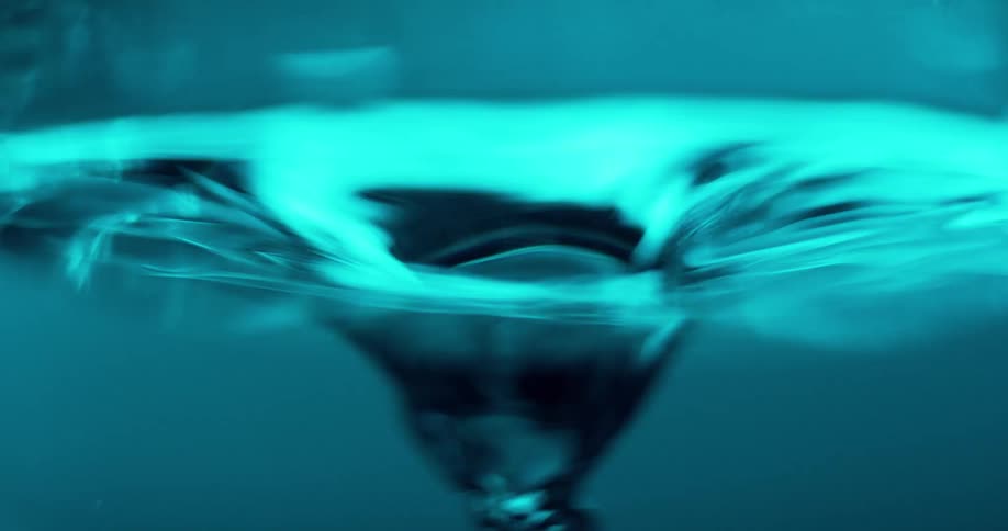 Liquid reflects bright blue as eddy tries to form vortex
