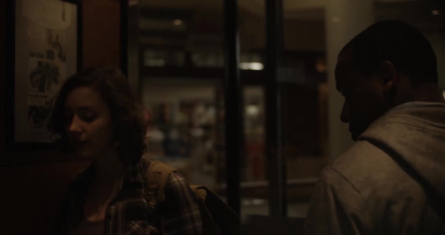 A man and woman walk into a building