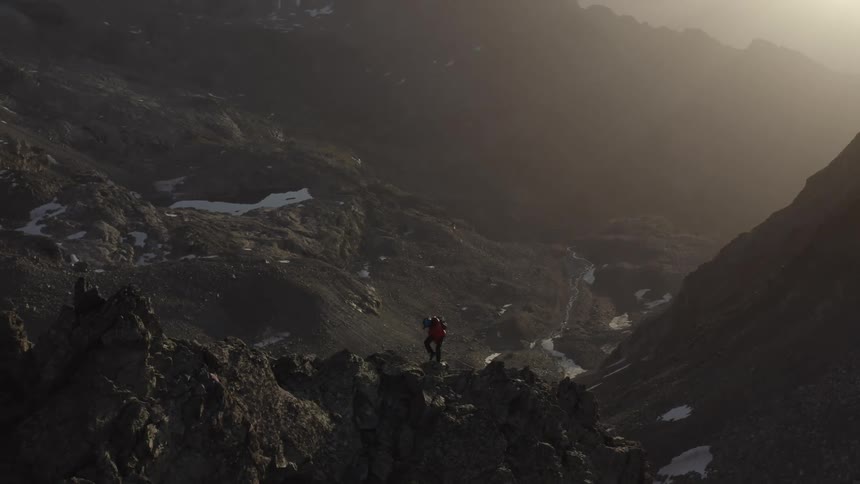 A person hikes up the side of a mountain