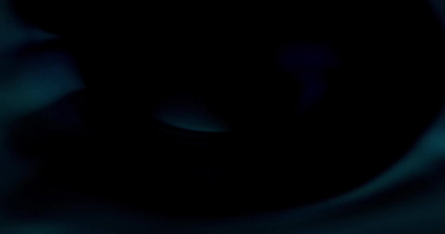 Bright vividly colored fluid forms eddy as area brightens and darkens