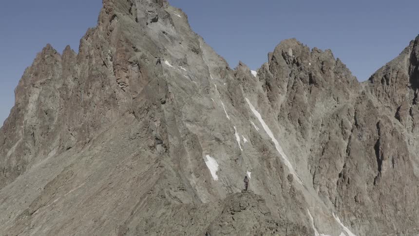 A person is climbing the tall mountain