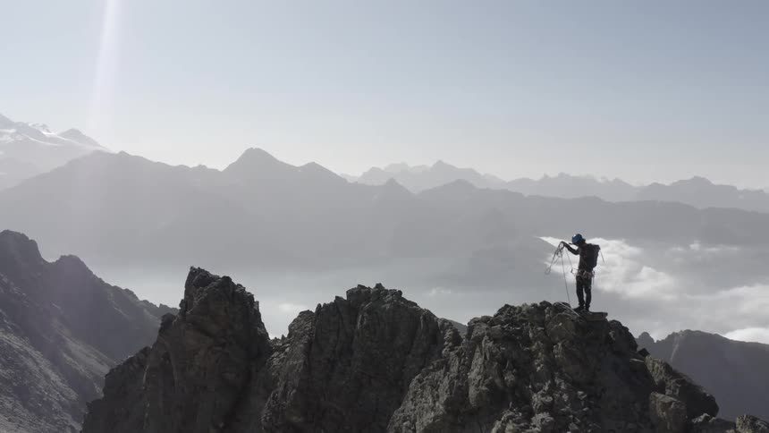 A man is hiking on top of the mountain