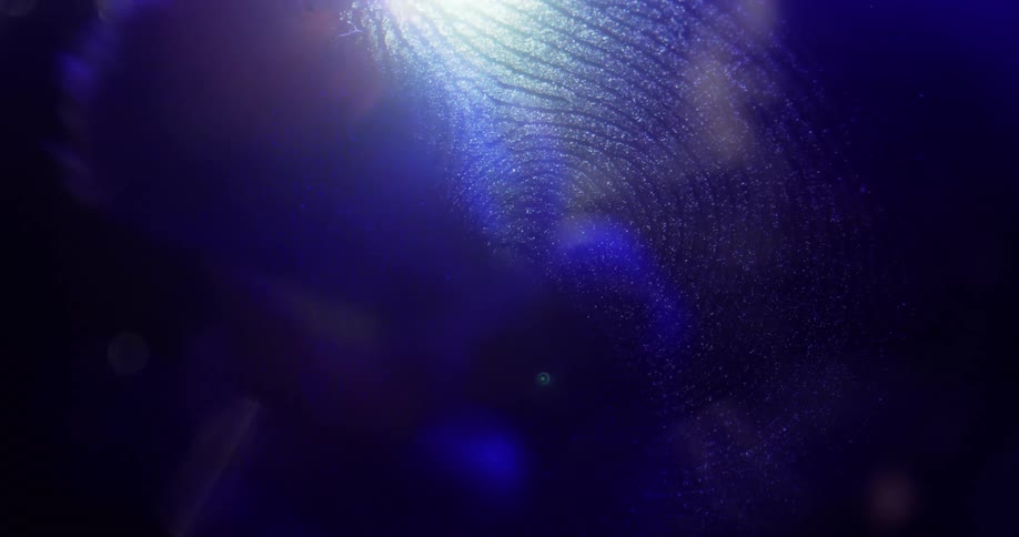 Crime scene tech swishes brush across fingerprint as hand is colored red and blue by lighting