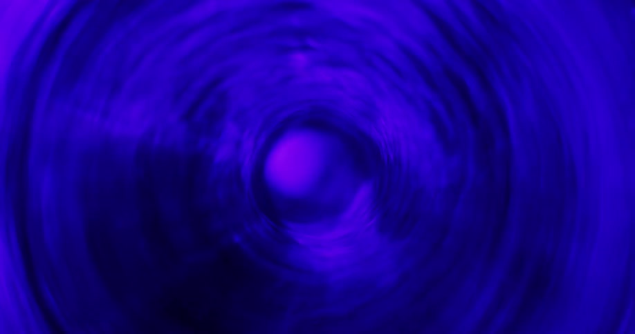 A tunnel vortex is rapidly spinning and the light changes color every time it goes dark