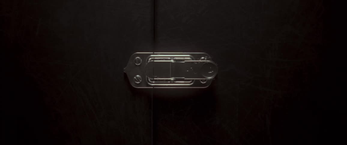 Light shines on a silver clasp on a briefcase