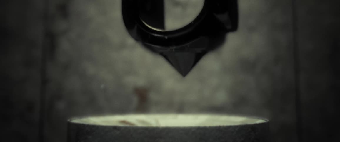A pendulum swings in a glass display case