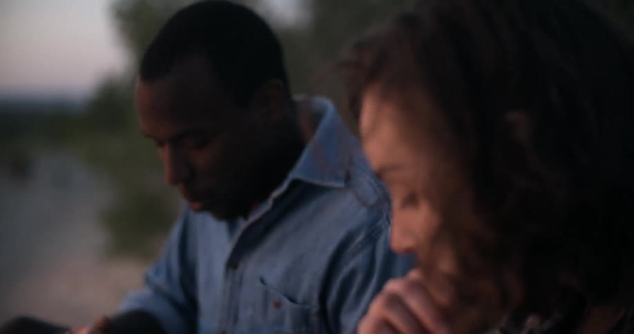 A man and woman eat and talk