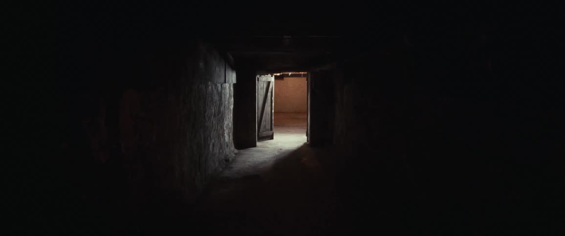 Open wooden door lets light into hallway