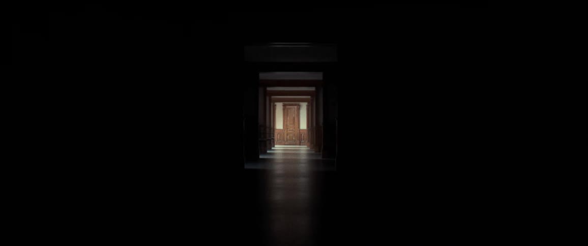 A dark hallway that slowly lightens up revealing a room