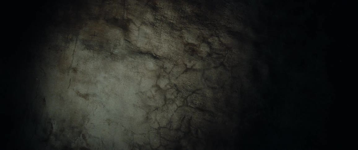 The shadow of a human on a rocky wall