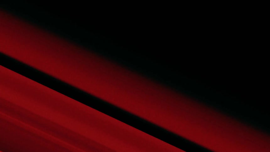 Glowing red bars move in the darkness with a red laser beam