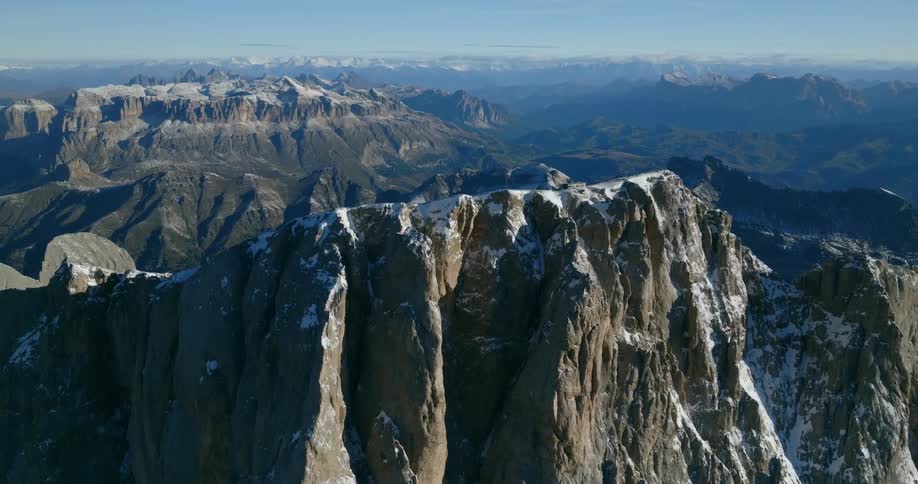 An orbiting aerial view of a mountain ridge on a mountain landscape during the daytime