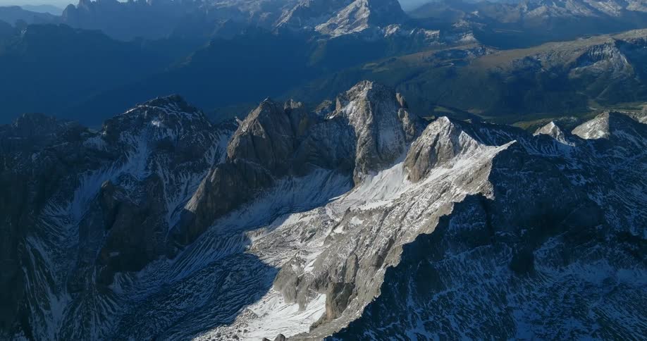 Aerial view of snow covered mountains is displayed